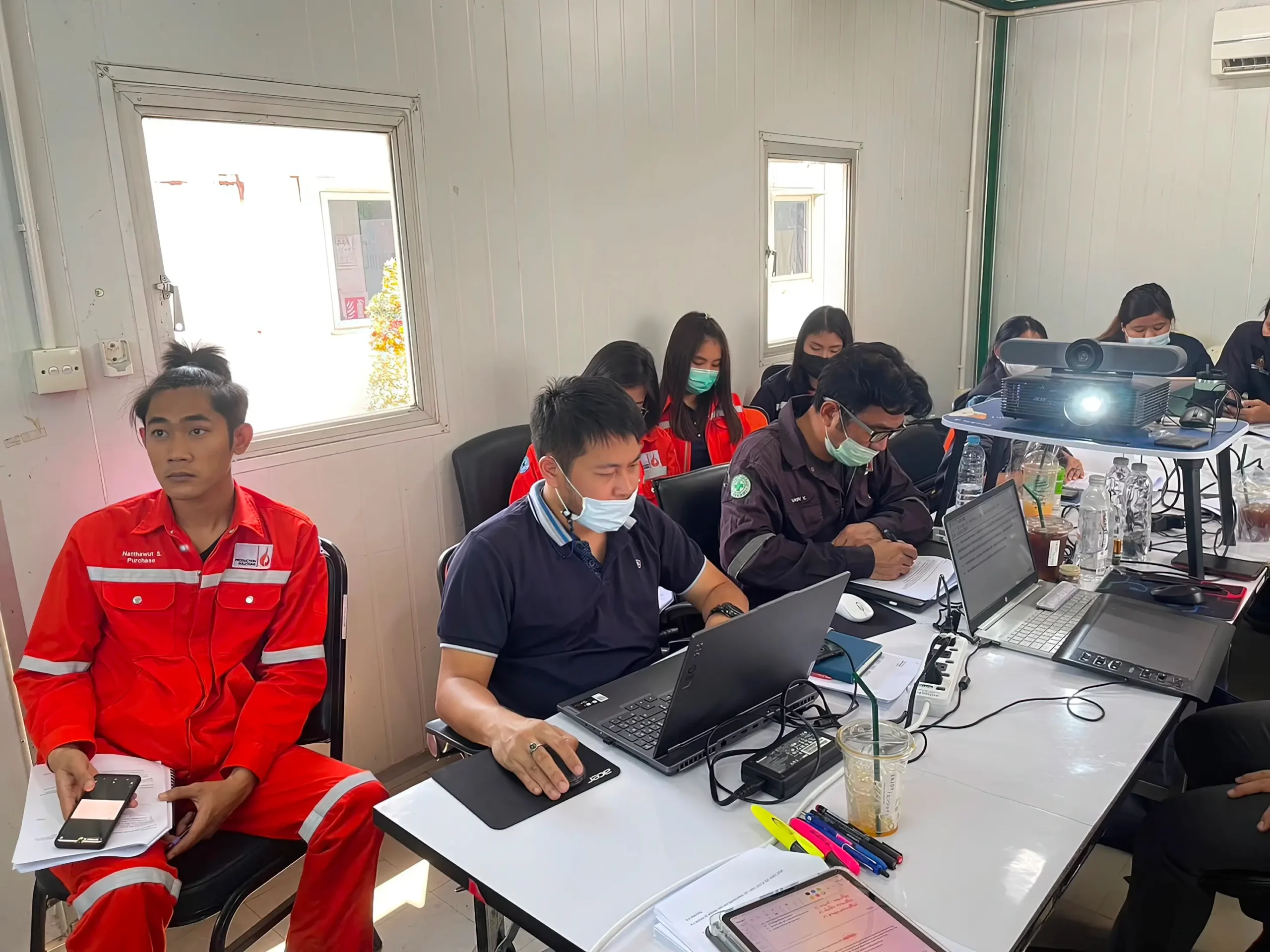 Group of university interns engaged in focused studies and collaborative learning at Production Solutions Thailand.